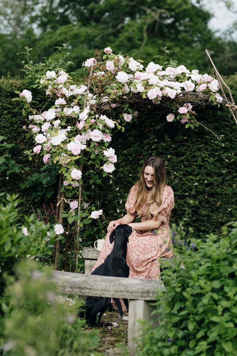 Image may contain: Clothing, Apparel, Human, Person, Outdoors, Garden, Arbour, Evening Dress, Fashion, Gown, Robe, and Plant