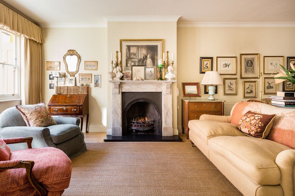 Image may contain Living Room Room Indoors Furniture Fireplace Interior Design Home Decor Hearth and Cushion