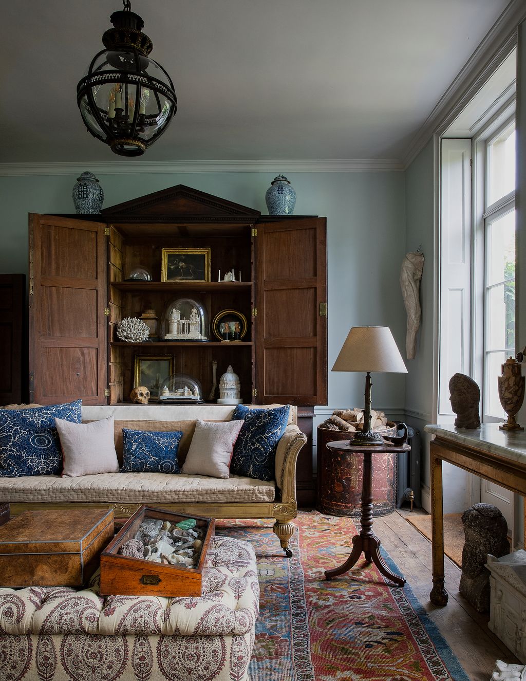 Image may contain Living Room Room Indoors Furniture Interior Design Couch Lamp Table Lamp and Rug