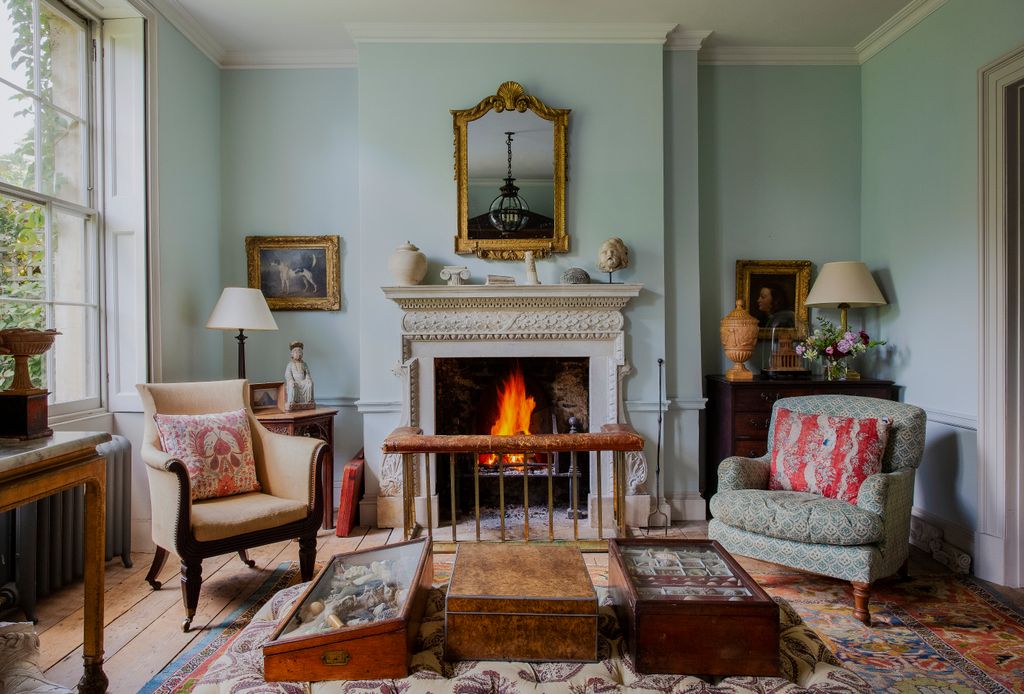 Image may contain Living Room Room Indoors Furniture Hearth Couch Fireplace Interior Design and Home Decor