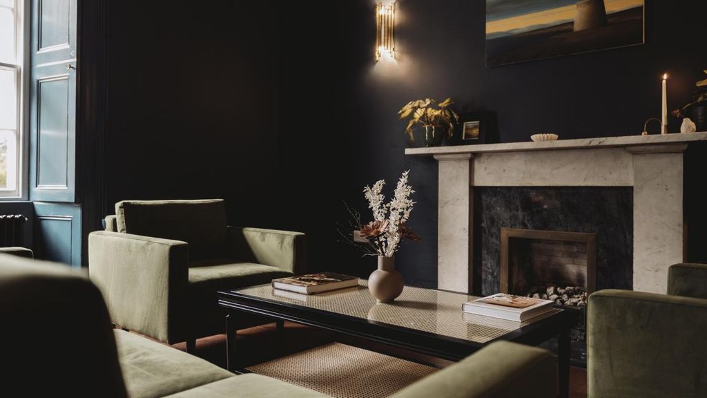 Image may contain Furniture Table Interior Design Indoors Fireplace Living Room Room Coffee Table Hearth and Couch