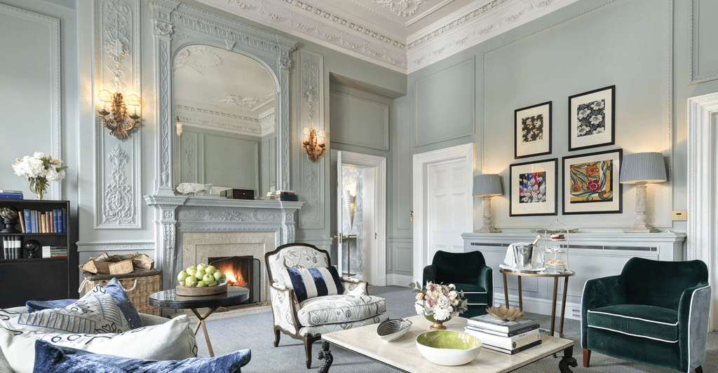 Image may contain Furniture Living Room Indoors Room Table Interior Design Coffee Table and Fireplace