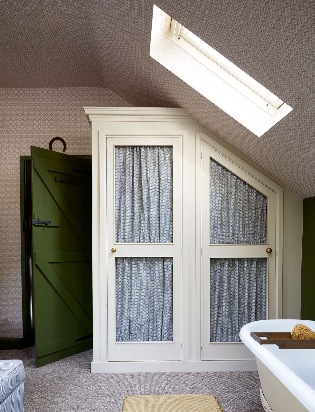 The room is covered in a wallpaper from GPJ Baker paired with olive green paint on the woodwork.