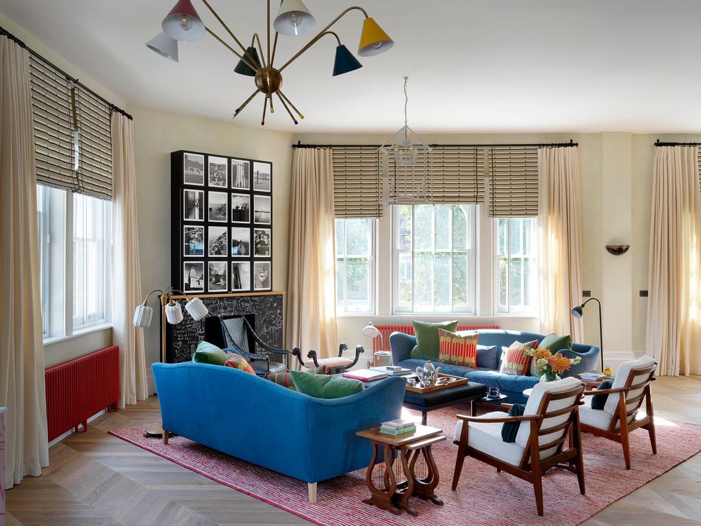 Image may contain Furniture Living Room Indoors Room Ceiling Fan Appliance Table Couch and Rug