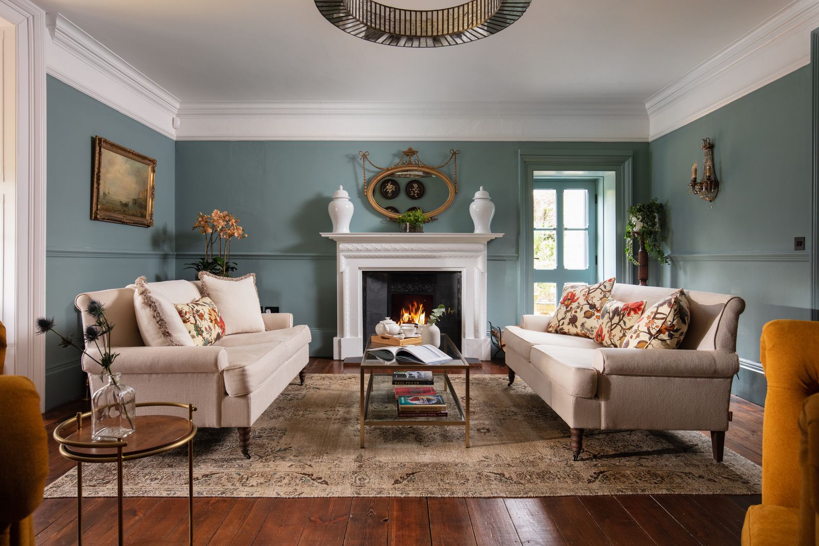 Image may contain Living Room Room Indoors Flooring Hardwood Wood Furniture Interior Design Table Couch and Floor