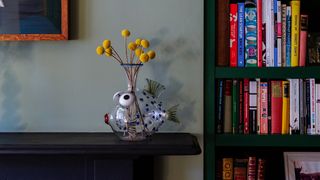 Image may contain Furniture Shelf Bookcase Vase Pottery Jar Plant Interior Design Indoors Home Decor and Flower