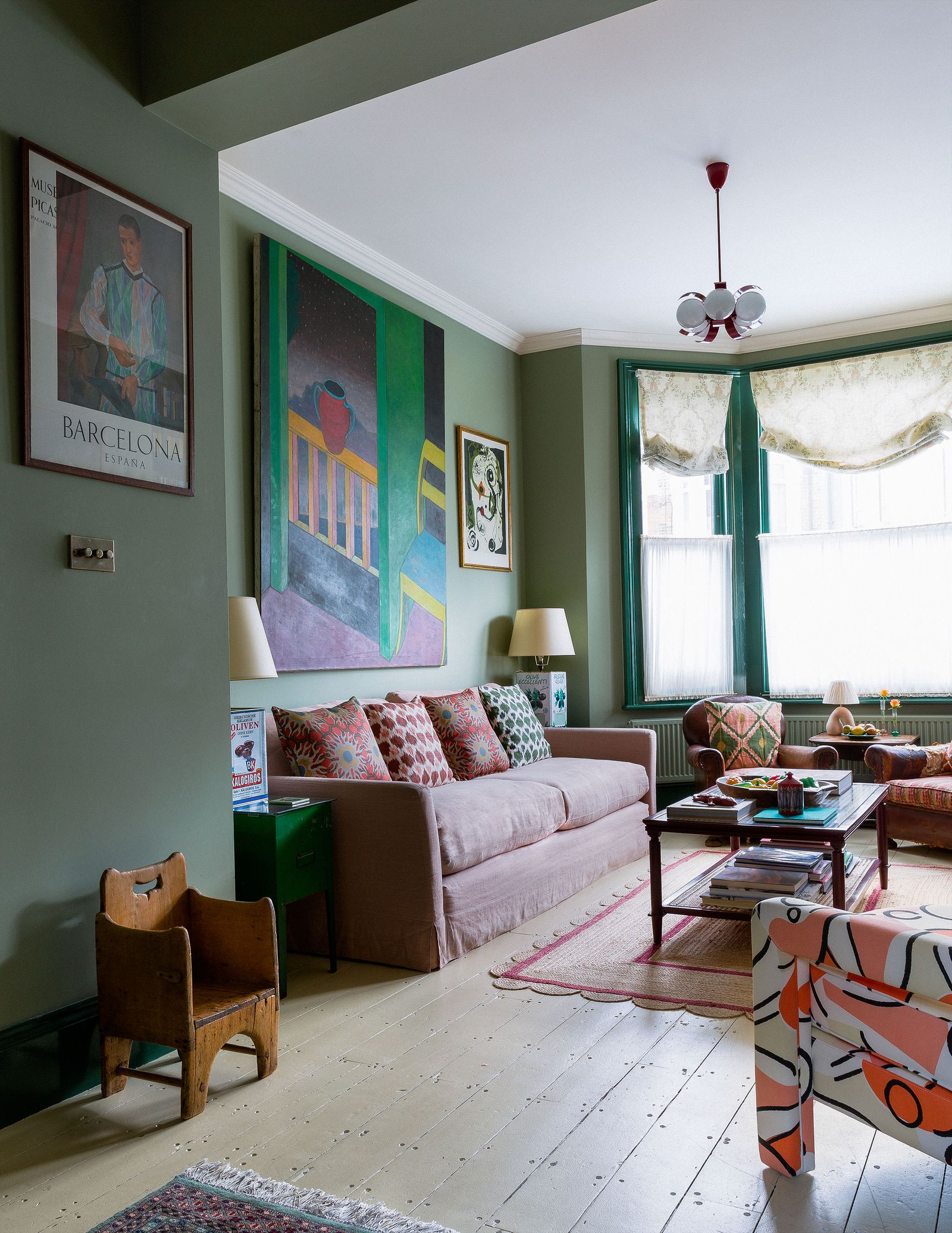 Image may contain Furniture Living Room Indoors Room Couch Table Flooring Human Person Interior Design and Rug