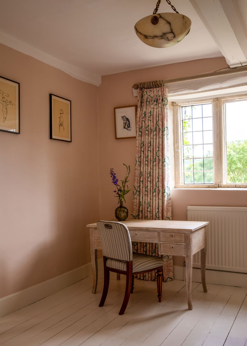 Image may contain Furniture Chair Flooring Wood Indoors Interior Design Corner Table Plant Flower and Blossom