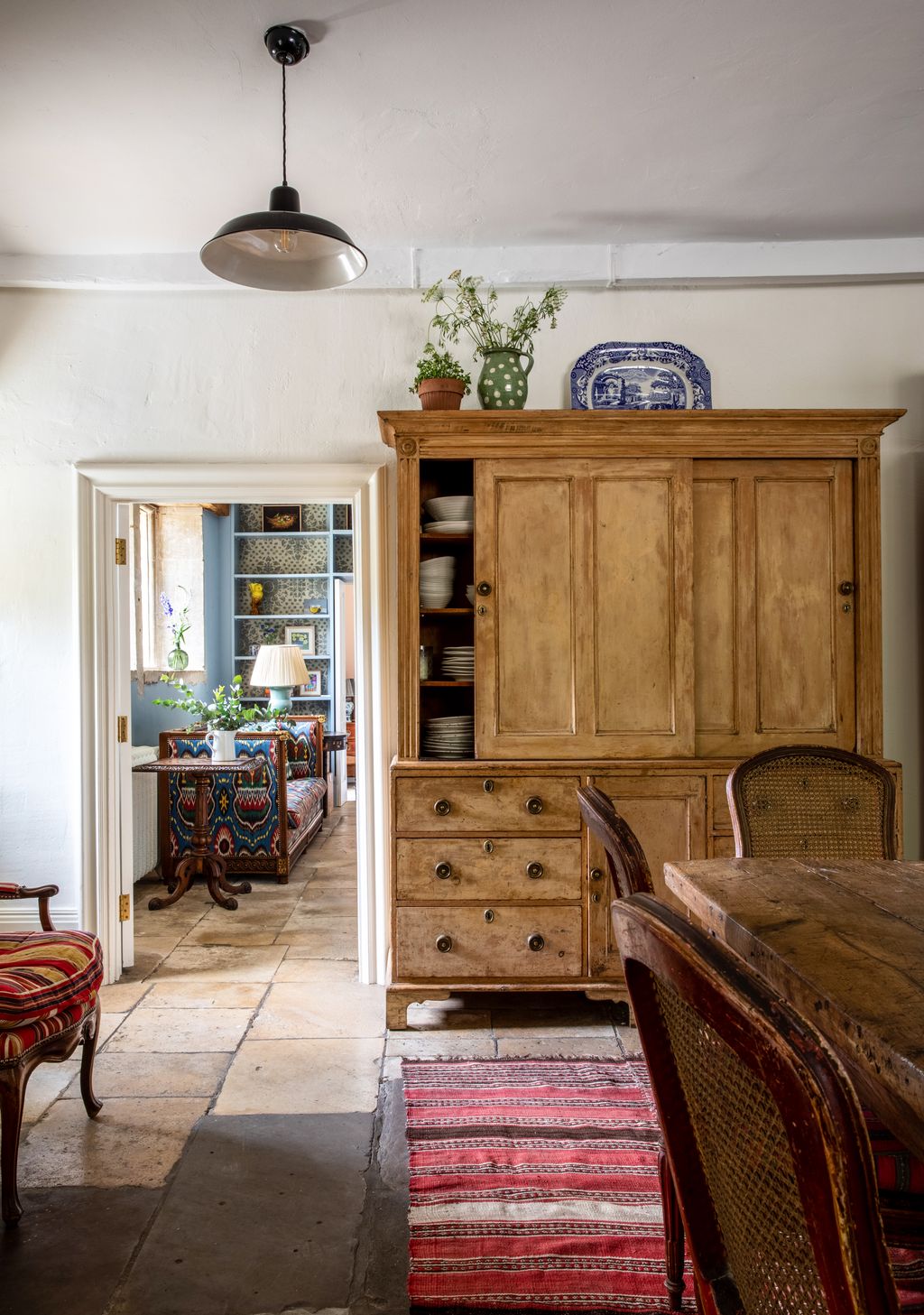 Image may contain Furniture Chair Shelf Living Room Room Indoors Wood Cupboard and Closet