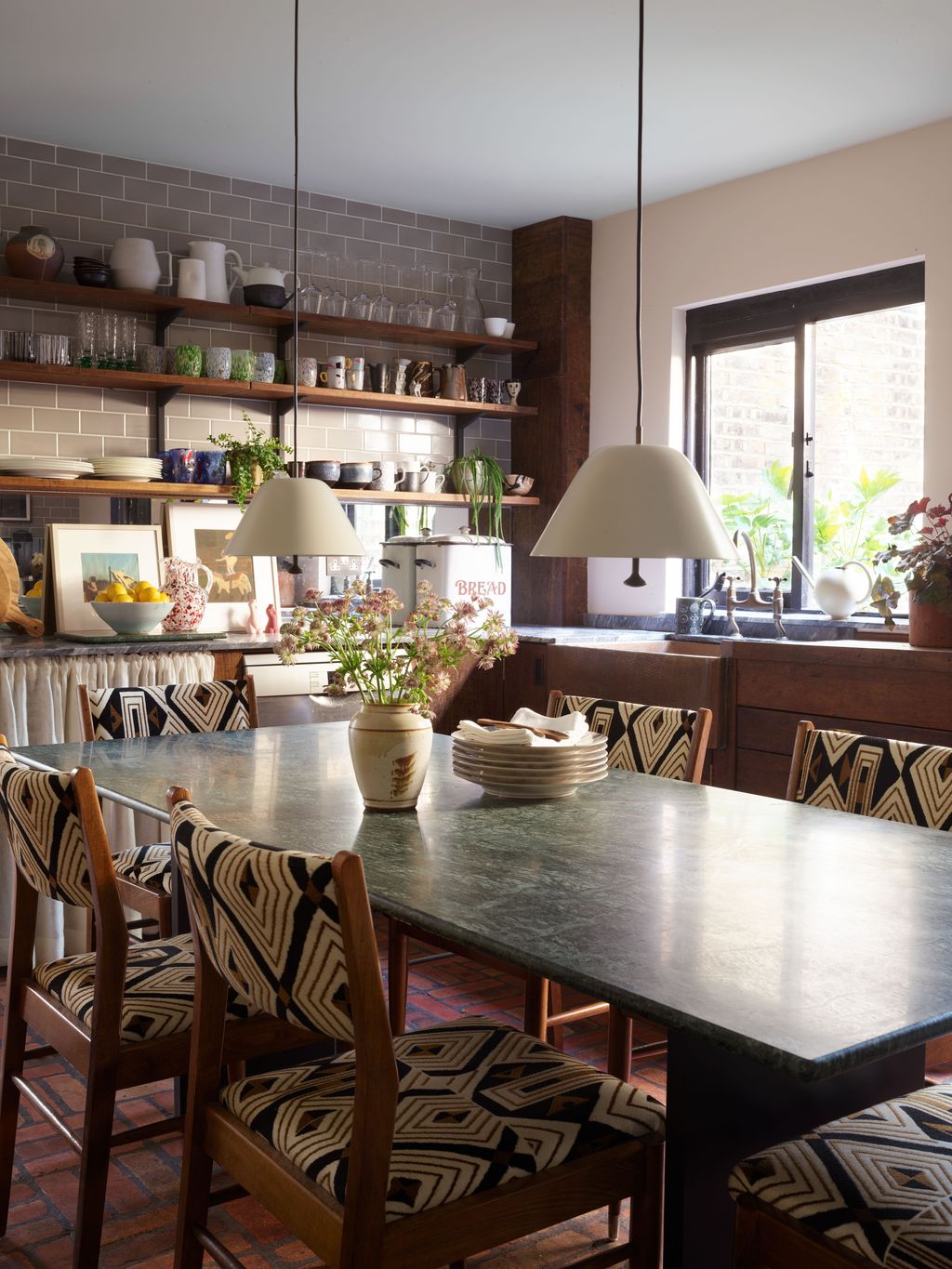 Image may contain Furniture Chair Room Indoors Dining Table Table Interior Design Shelf Dining Room and Wood