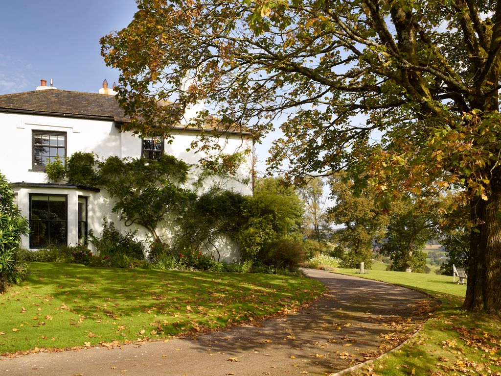 Image may contain Plant Tree Tree Trunk Building Grass and Housing