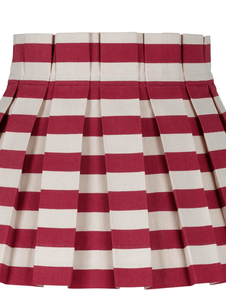 Image may contain: Clothing, Apparel, Skirt, and Rug