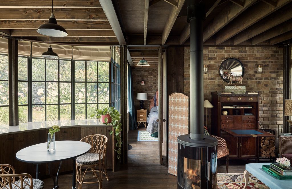 Image may contain Furniture Chair Floor Flooring Human Person Wood Indoors Interior Design Hardwood and Table