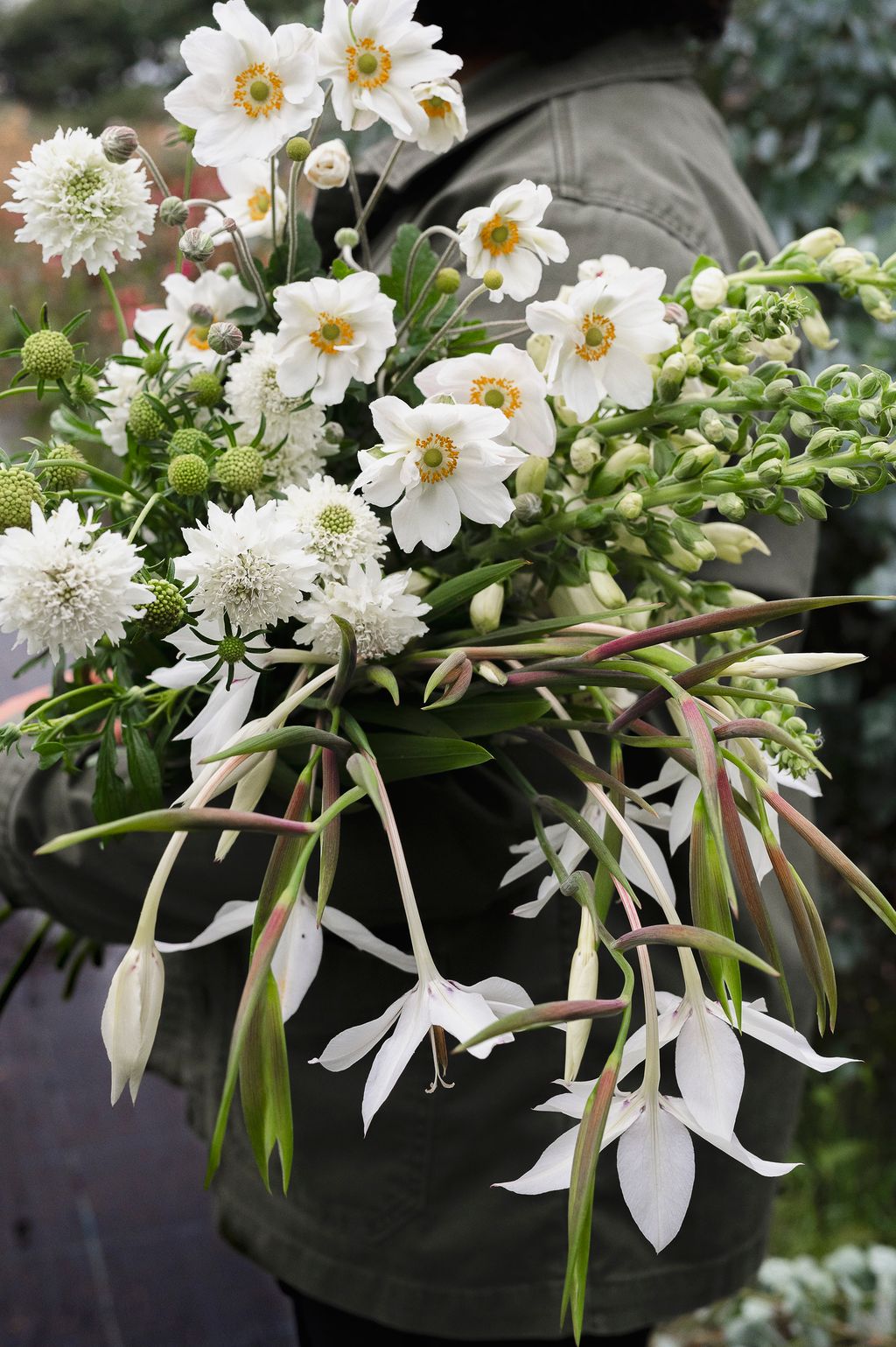 Image may contain Plant Human Person Flower Blossom Flower Arrangement and Flower Bouquet