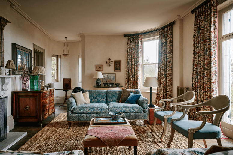 Image may contain: Living Room, Room, Indoors, Furniture, Couch, Flooring, Chair, Interior Design, Electronics, and Monitor