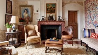 Image may contain Furniture Indoors Living Room Room Fireplace Hearth Home Decor Interior Design and Rug