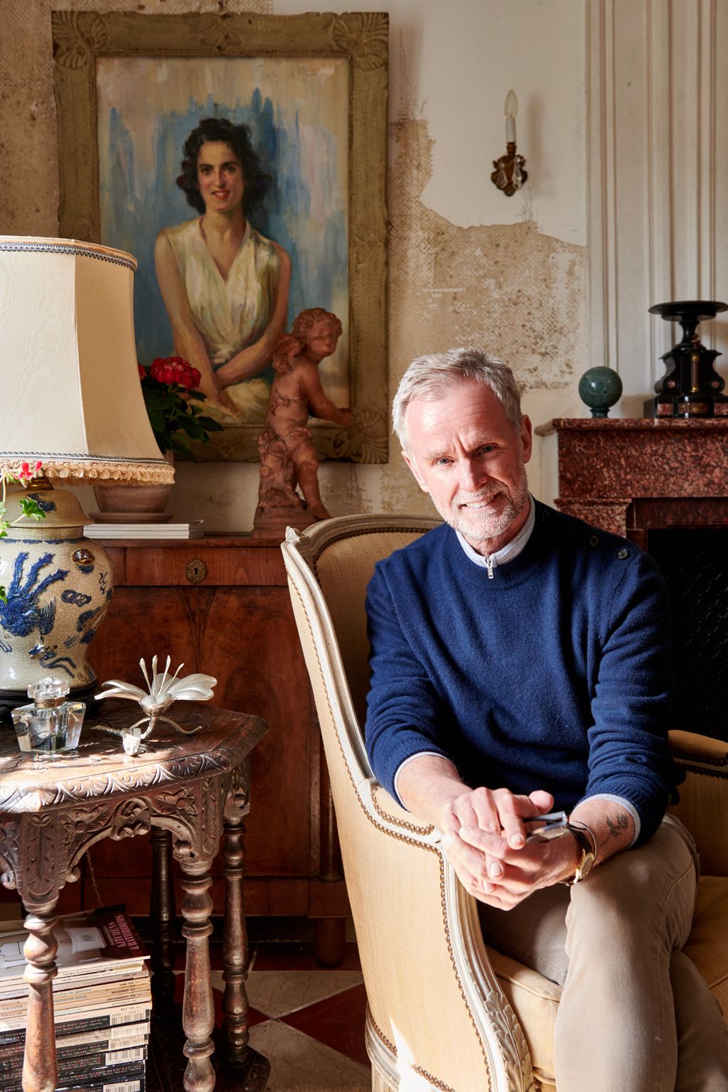 Image may contain Human Person Furniture Lamp Table Lamp Couch Wood and Chair