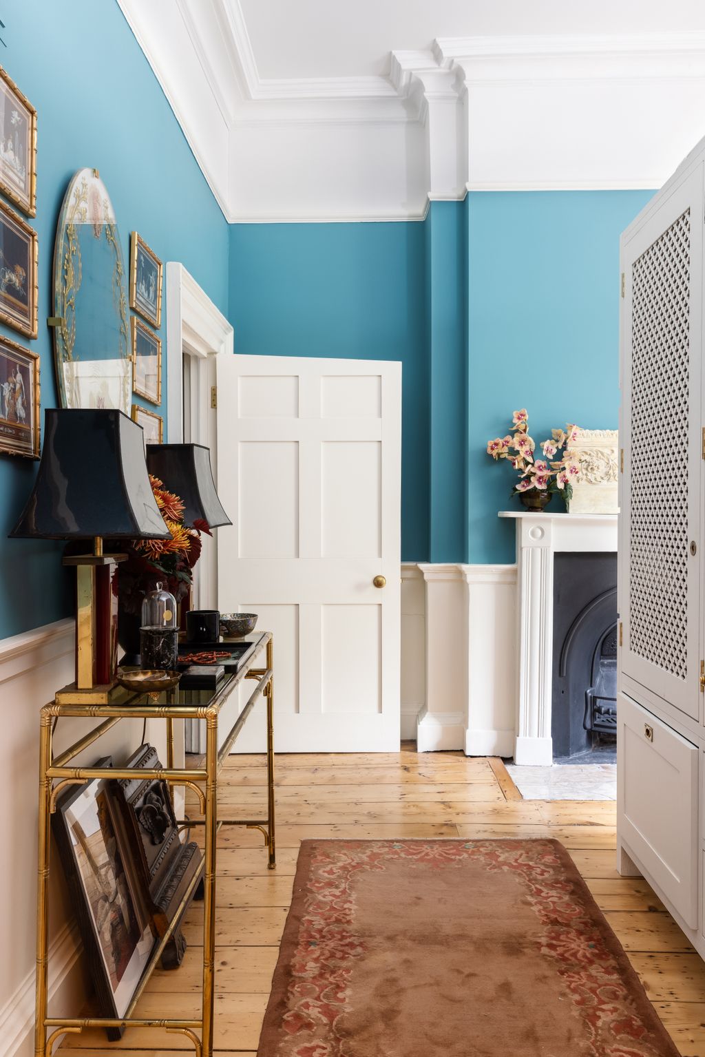 Image may contain Flooring Interior Design Indoors Wood Living Room Room Furniture Floor Hardwood Rug and Shelf