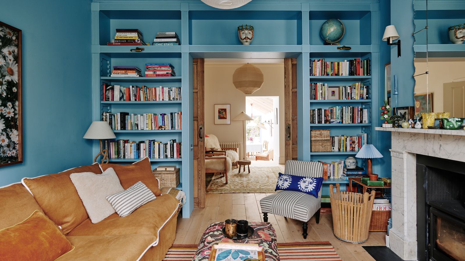 Image may contain: Furniture, Living Room, Room, Indoors, Couch, Interior Design, Bookcase, Table, Chair, and Shelf