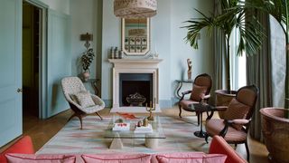 Image may contain Living Room Room Indoors Interior Design Furniture Chair Flooring Fireplace Hearth and Home Decor