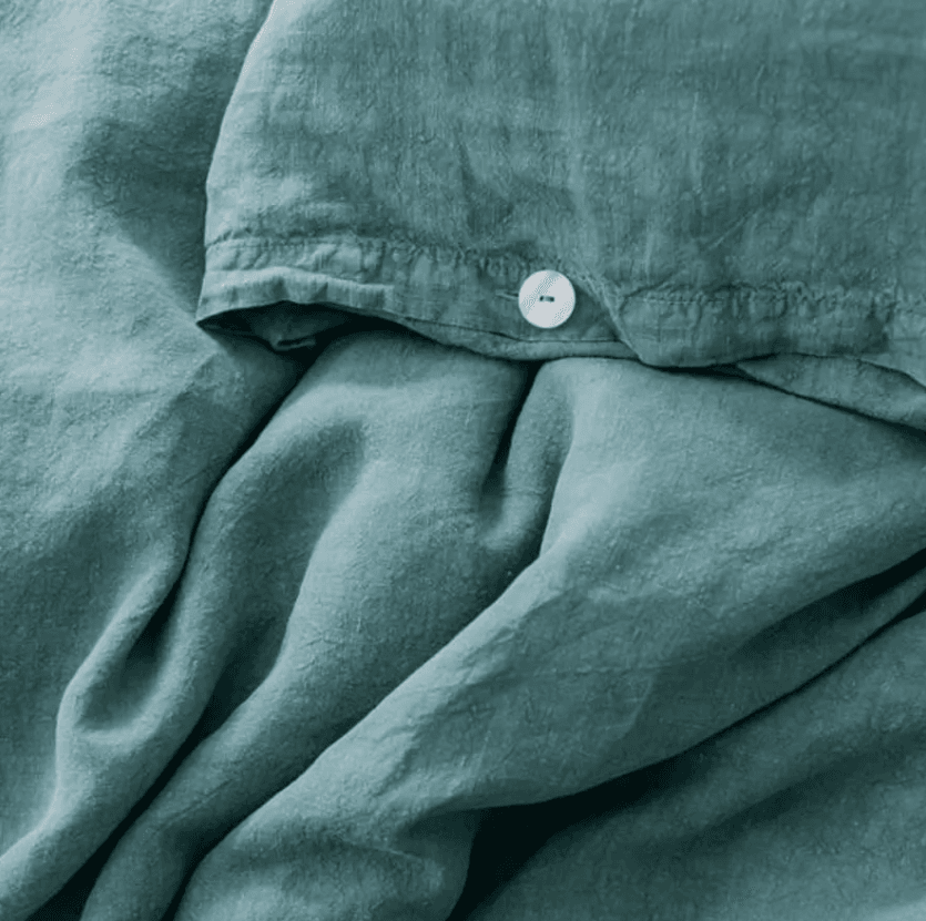 Image may contain Home Decor Linen Clothing Apparel Pants Denim Jeans Cushion and Blanket