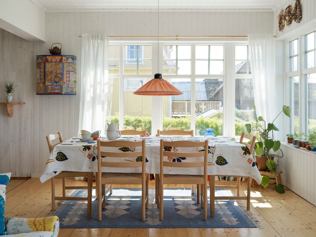 Image may contain Furniture Chair Room Indoors Interior Design Wood Flooring Dining Room Dining Table and Table