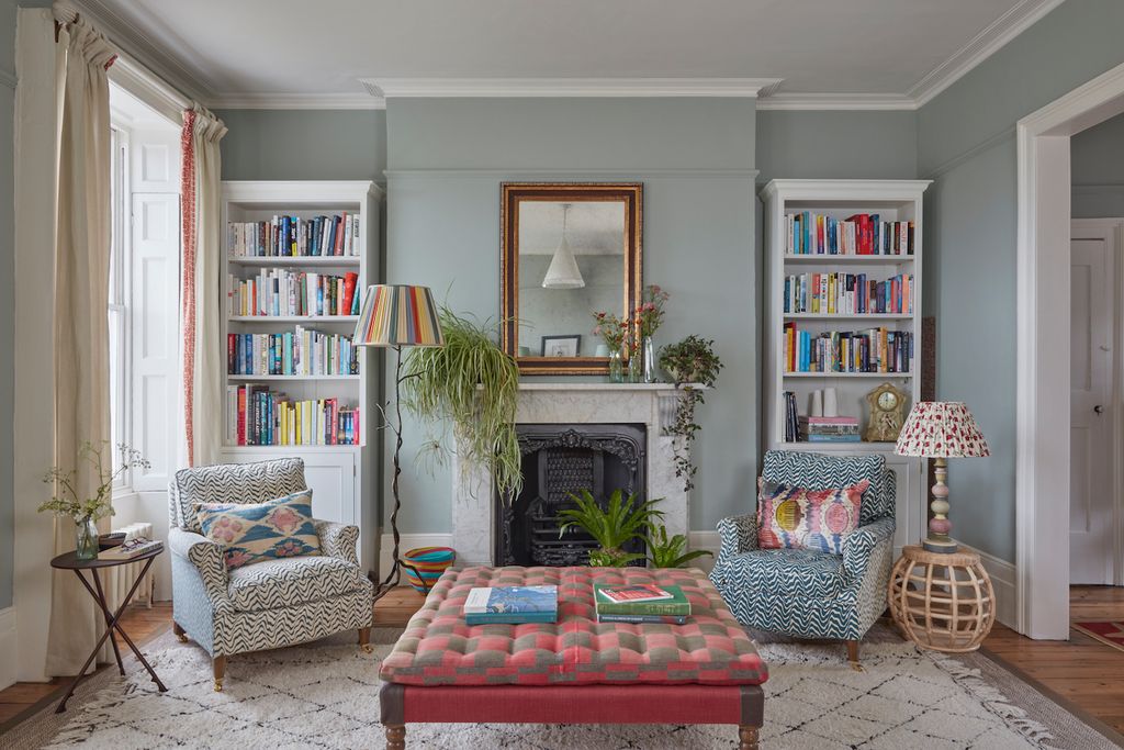 Image may contain Furniture Living Room Indoors Room Interior Design Couch Bookcase Cushion and Rug