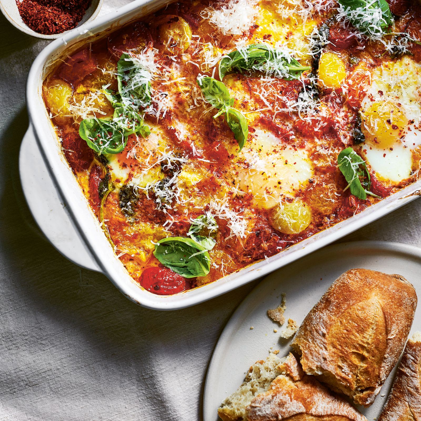 Baked tomatoes and eggs with basil, chilli and parmesan
