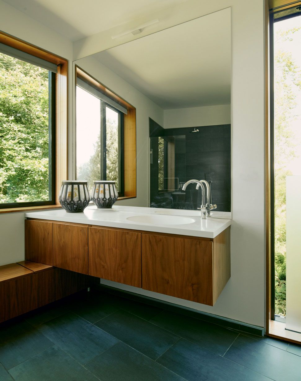 Grey porcelain tiles complement a walnut vanity.