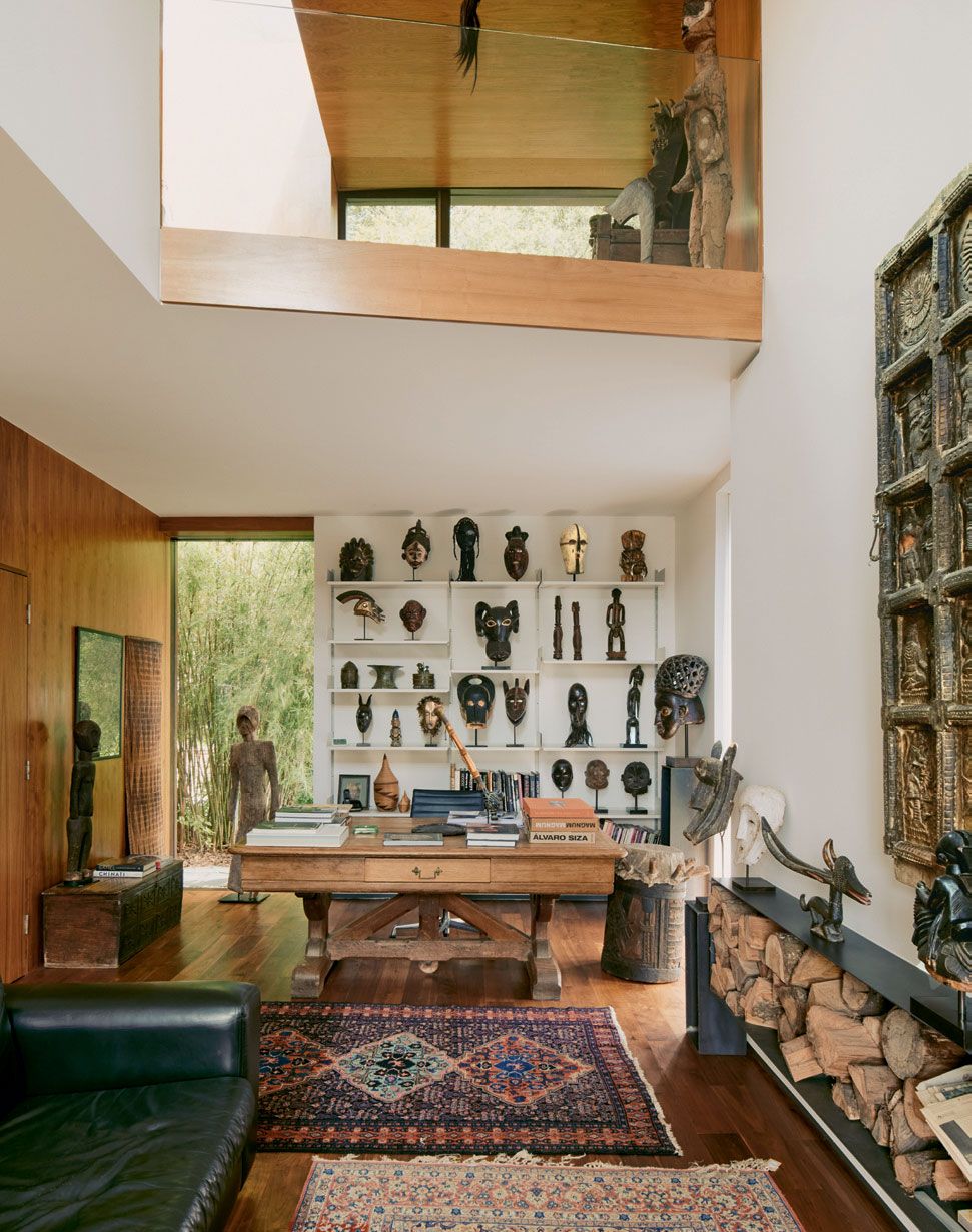 Image may contain Living Room Indoors Room Furniture Wood Shelf Flooring Human Person Hardwood and Interior Design