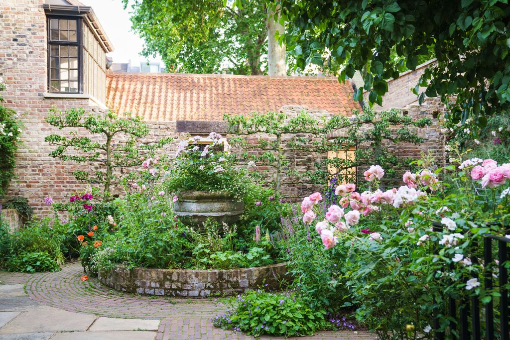 Filled with peonies foxgloves and a mass of roses the romantic walled garden of this Spitalfields townhouse was...