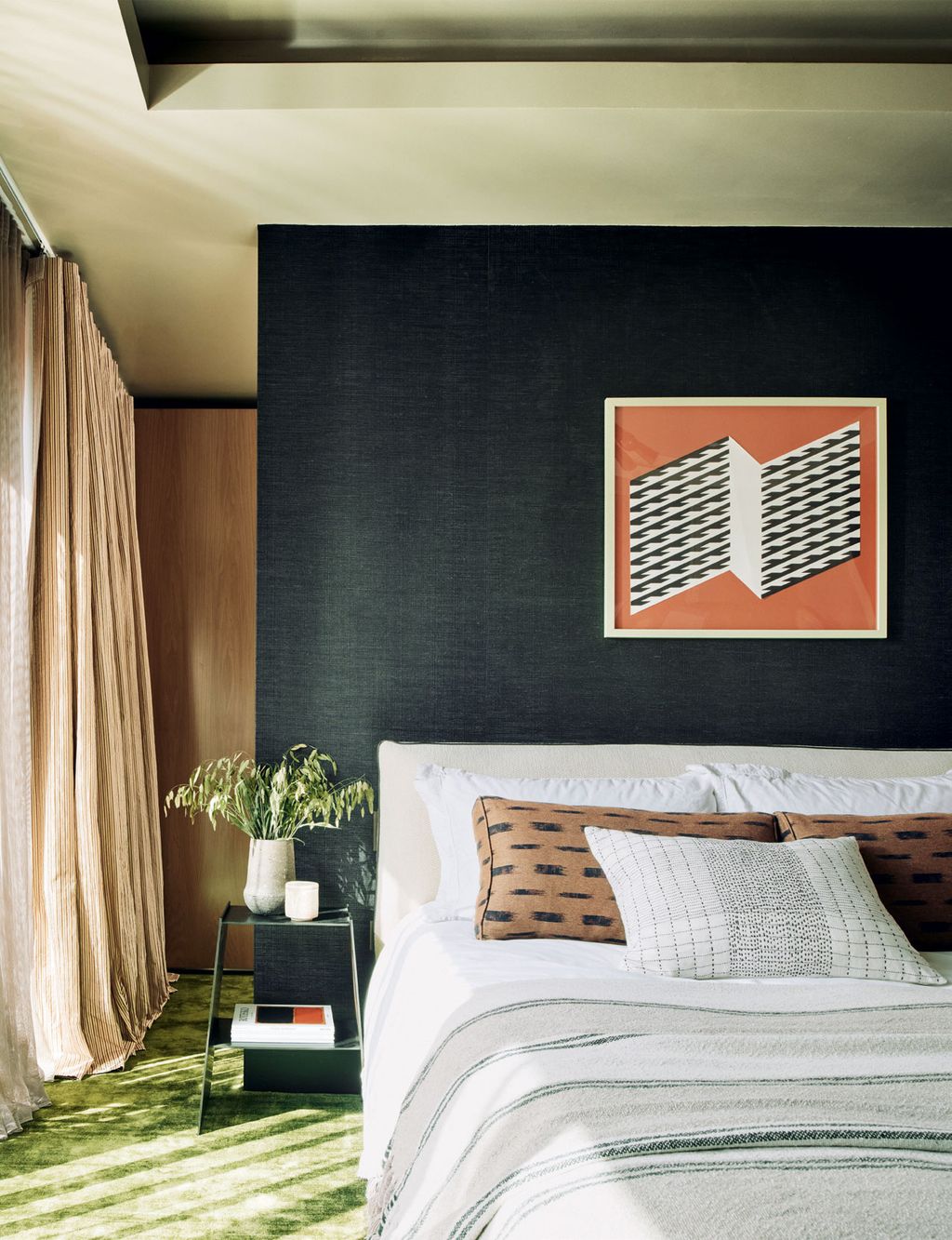 The black ‘Cazenac wallcovering by Casamance from Angela Brown sets off the red artwork purchased in Los Angeles. Light...