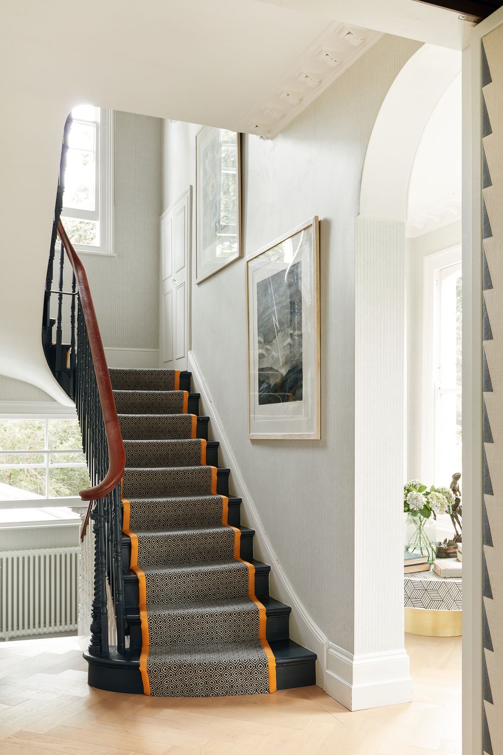 A set of David Hockney weather prints that were my Dads are lined up the stairs.nbsp