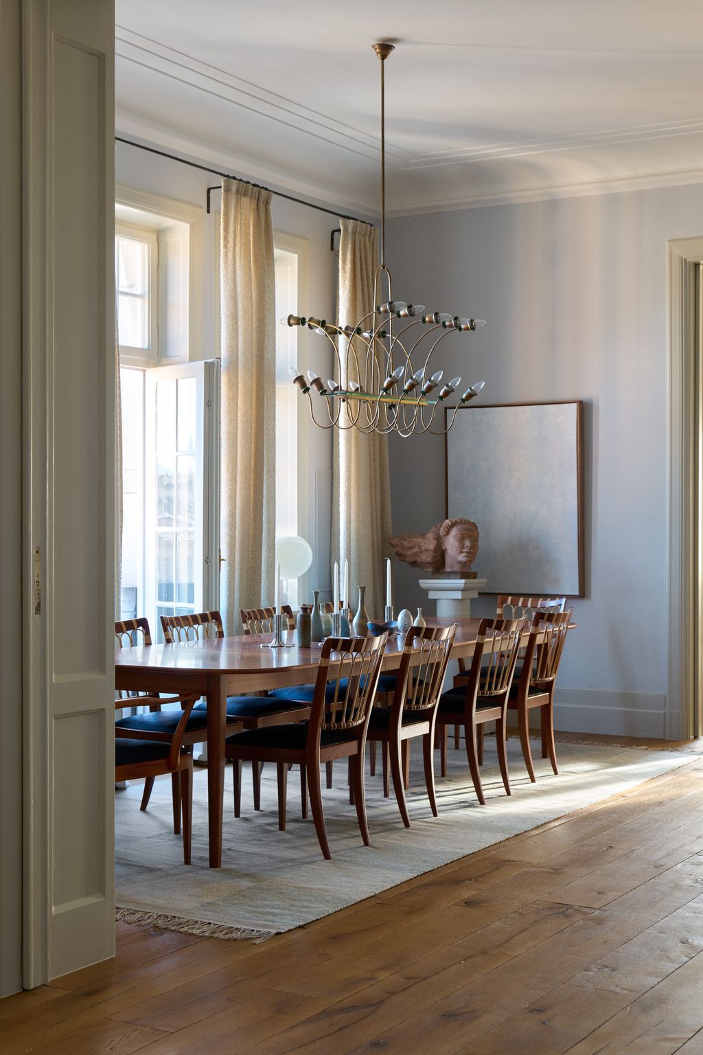 Image may contain Furniture Chair Room Indoors Dining Room Floor Flooring Interior Design Wood and Hardwood