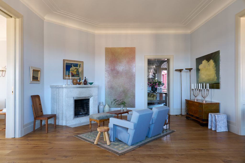 Image may contain Flooring Living Room Room Indoors Hardwood Wood Floor Furniture Couch Chair and Rug