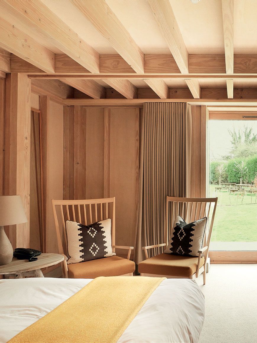 Image may contain Wood Furniture Bed Chair Room Indoors Interior Design Bedroom and Living Room