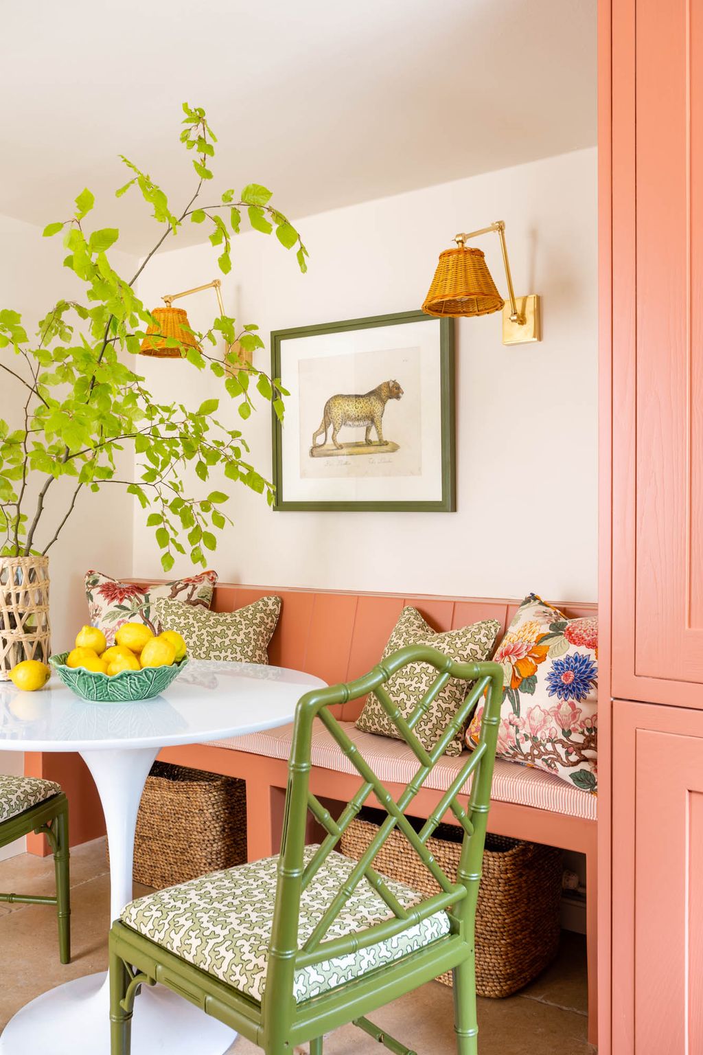 A builtin banquette  also in ‘Red Earth makes the best use of the space in the kitchen and features Vaughan wall lights...