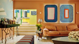 Image may contain Living Room Room Indoors Furniture Couch Table Flooring Interior Design and Lobby