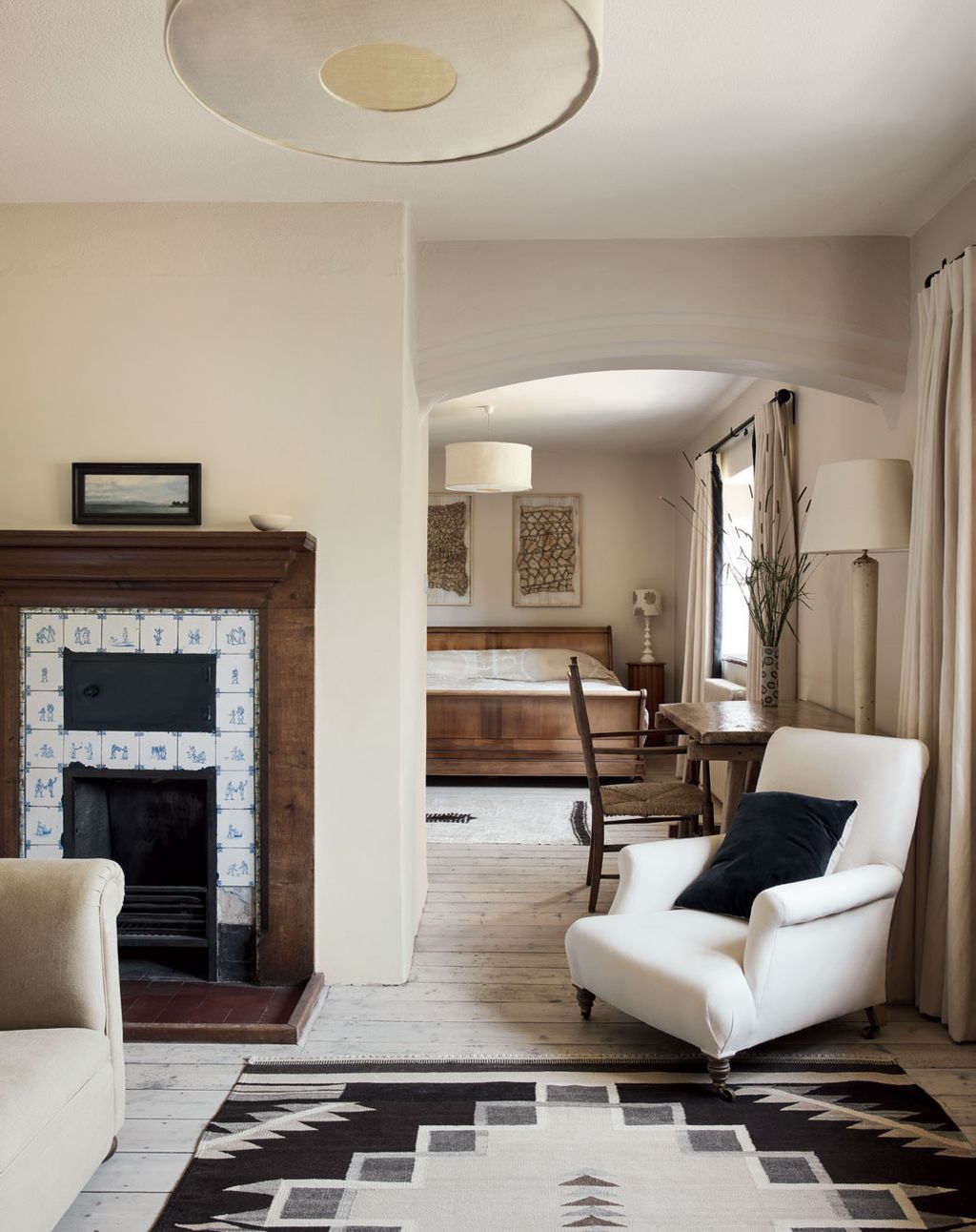 Navajo rugs from Joshua Lumley complement the pale limed floorboards. Original Delft tiles line the chimneypiece in the...