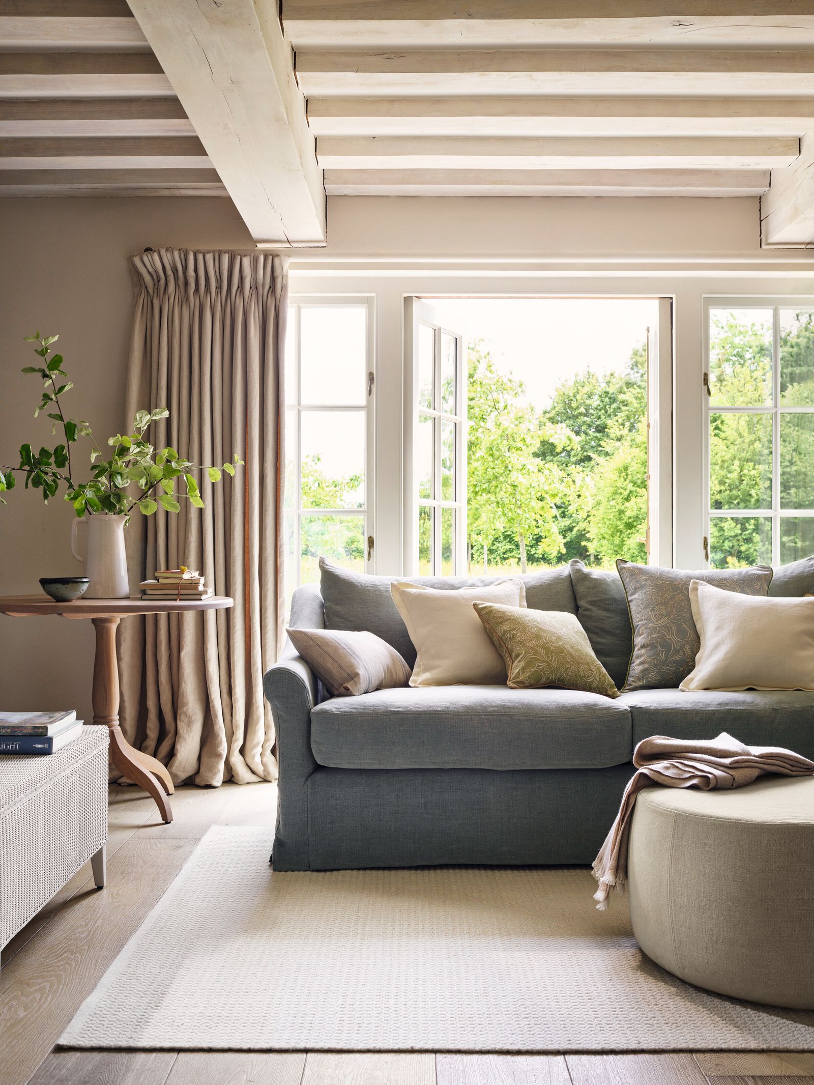 Image may contain Furniture Living Room Indoors Room Rug Table Cushion and Pillow