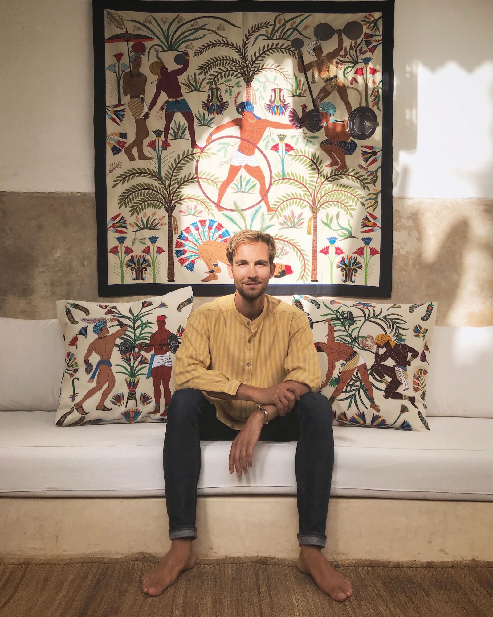 Image may contain Furniture Couch Cushion Pillow Human Person Home Decor Living Room Room and Indoors