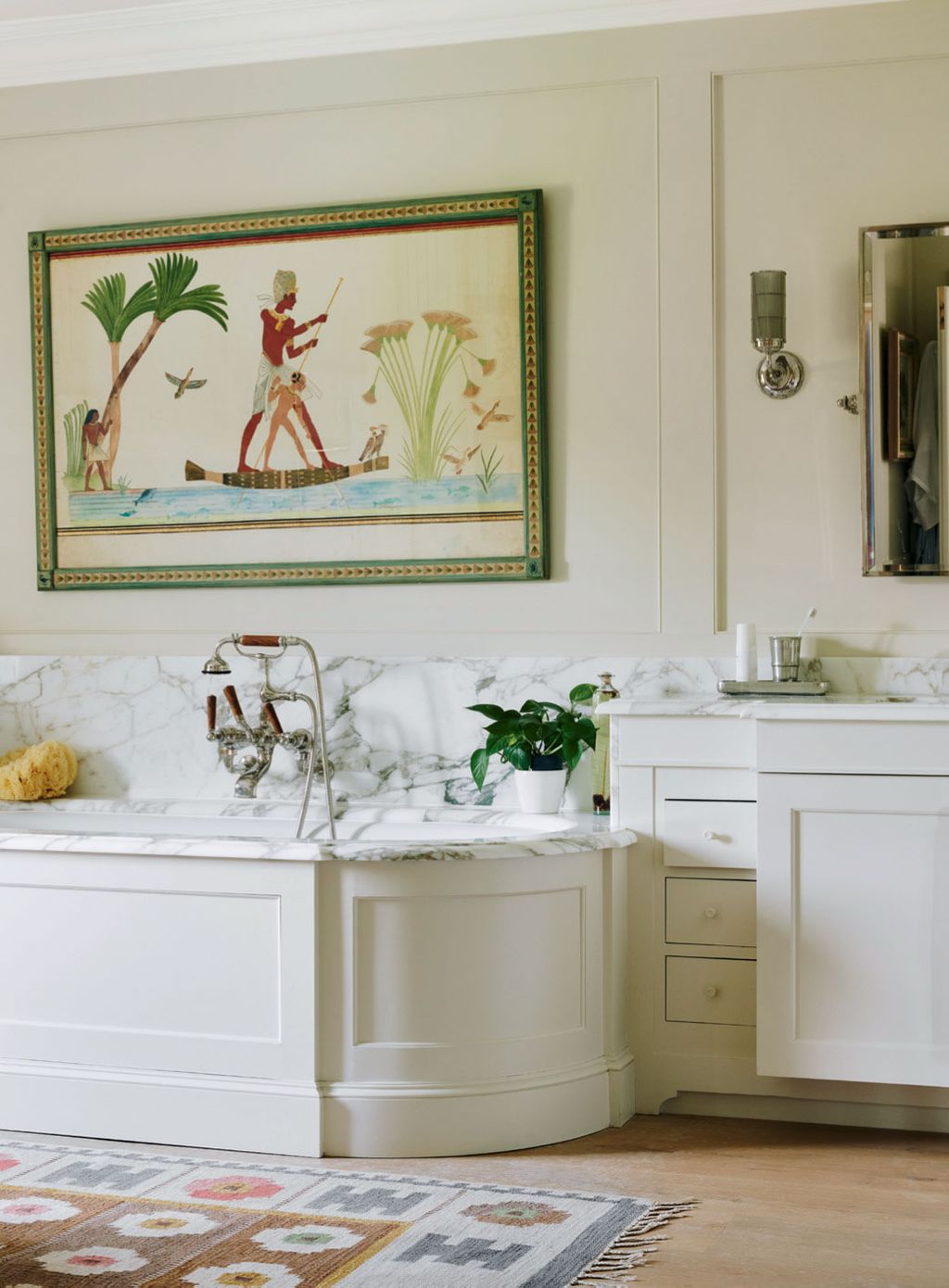 An antique rug from Foster Gane and an Egyptian watercolour from Talisman Fine Art provide a subtly colourful contrast...