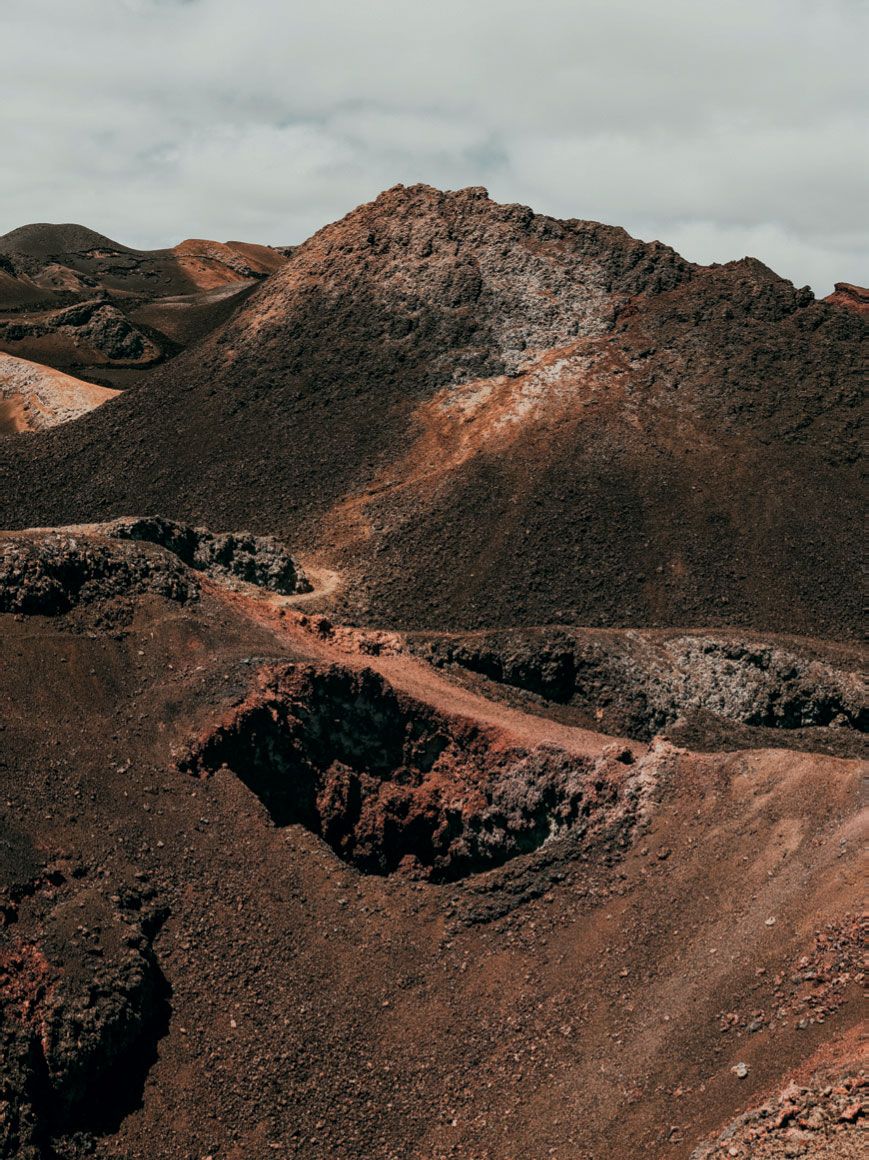 Image may contain Nature Outdoors Mountain Soil Plateau Ground Road and Countryside