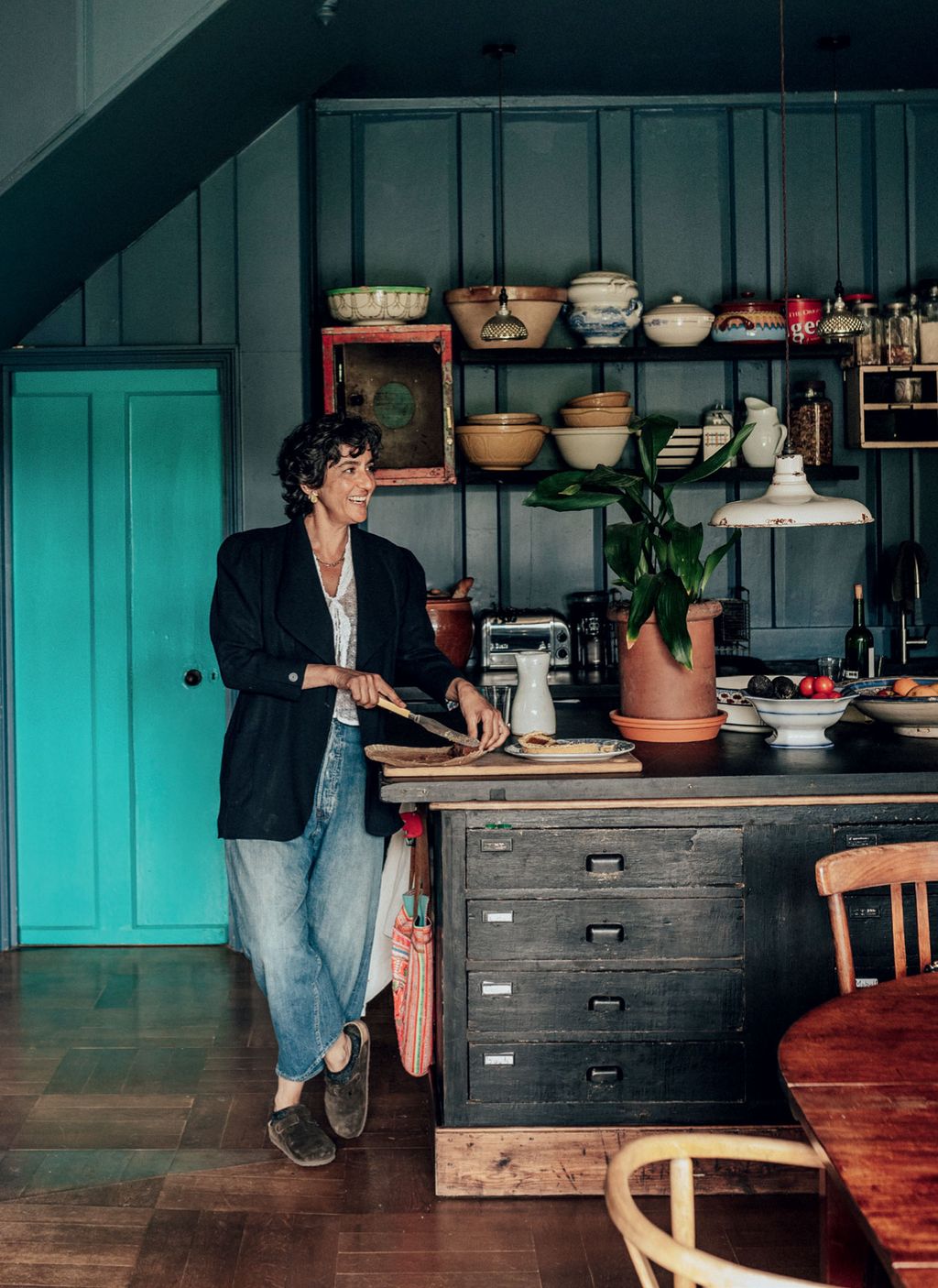 In the farmhouse kitchen a repurposed shop fitting with a slate top from an old snooker table provides ample preparation...
