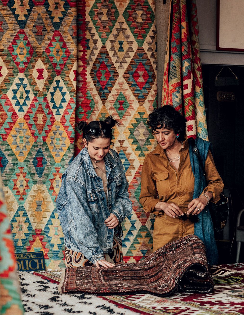 Geetie and her daughter Mabel hunt for antique rugs at Totnes Market held on Fridays and Saturdays.