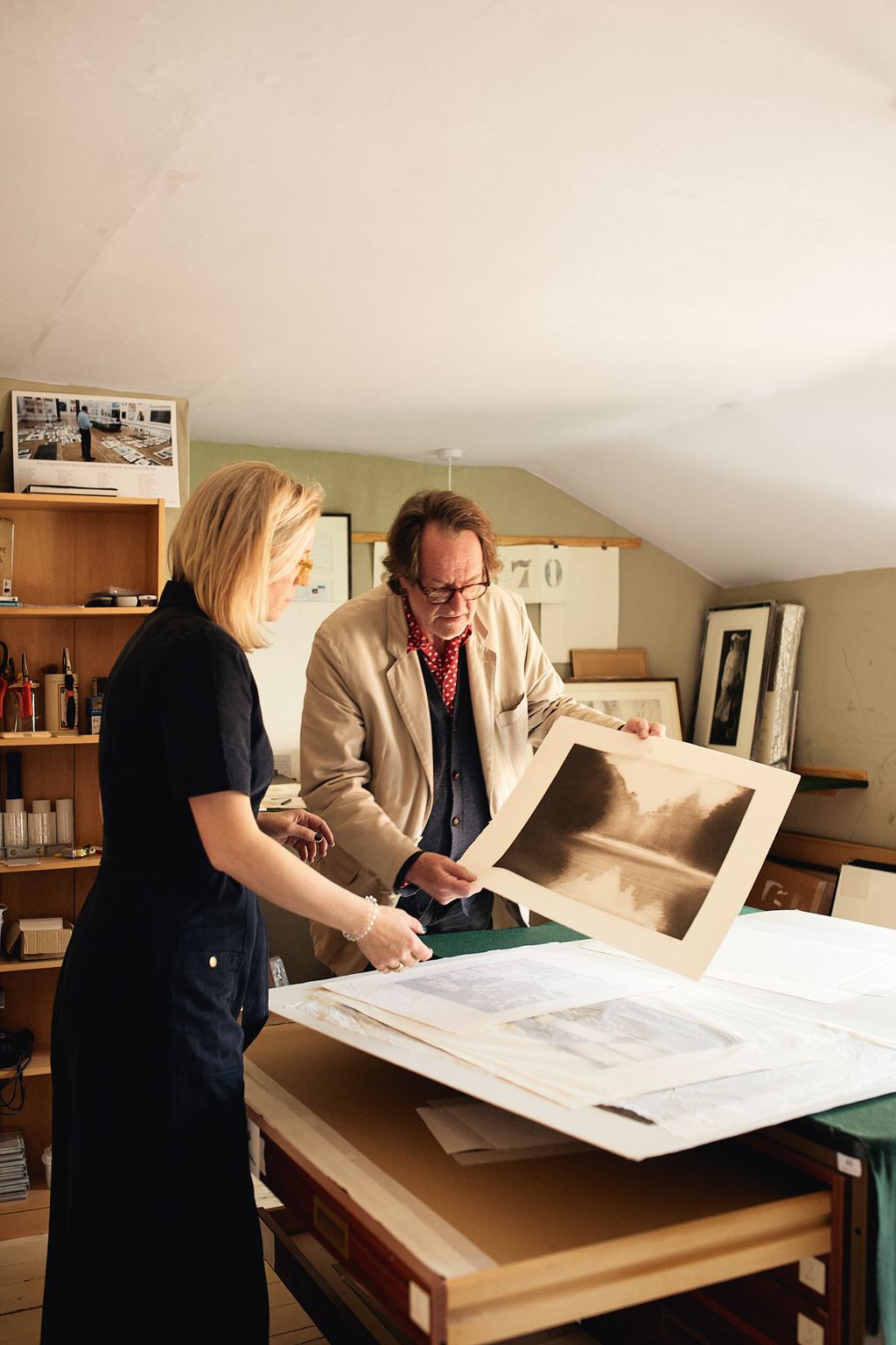 Daisy and her father John Bell look at Norman Ackroyd prints in Johns Thirsk gallery.