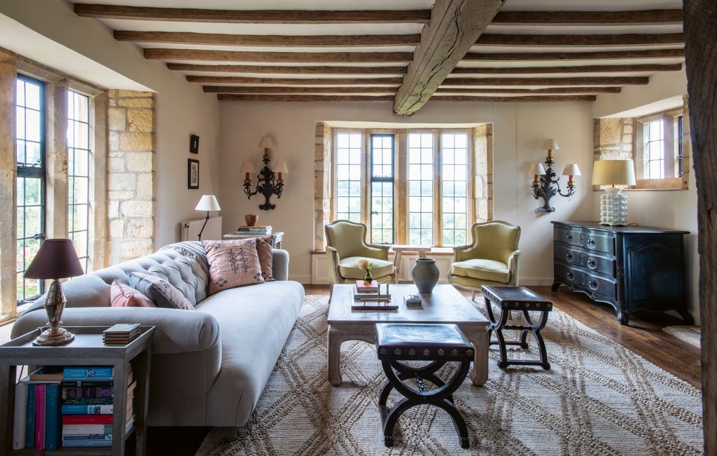 The drawing room is painted in Edward Bulmer Lilac Pink which turns into a warm pink in the evening light. The sofa is...