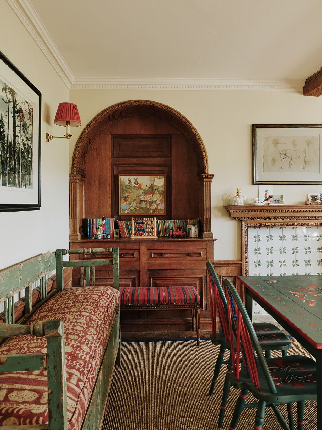 Centred around an antique table painted with folk motifs the children's playroom is a charming space. The fireplace...