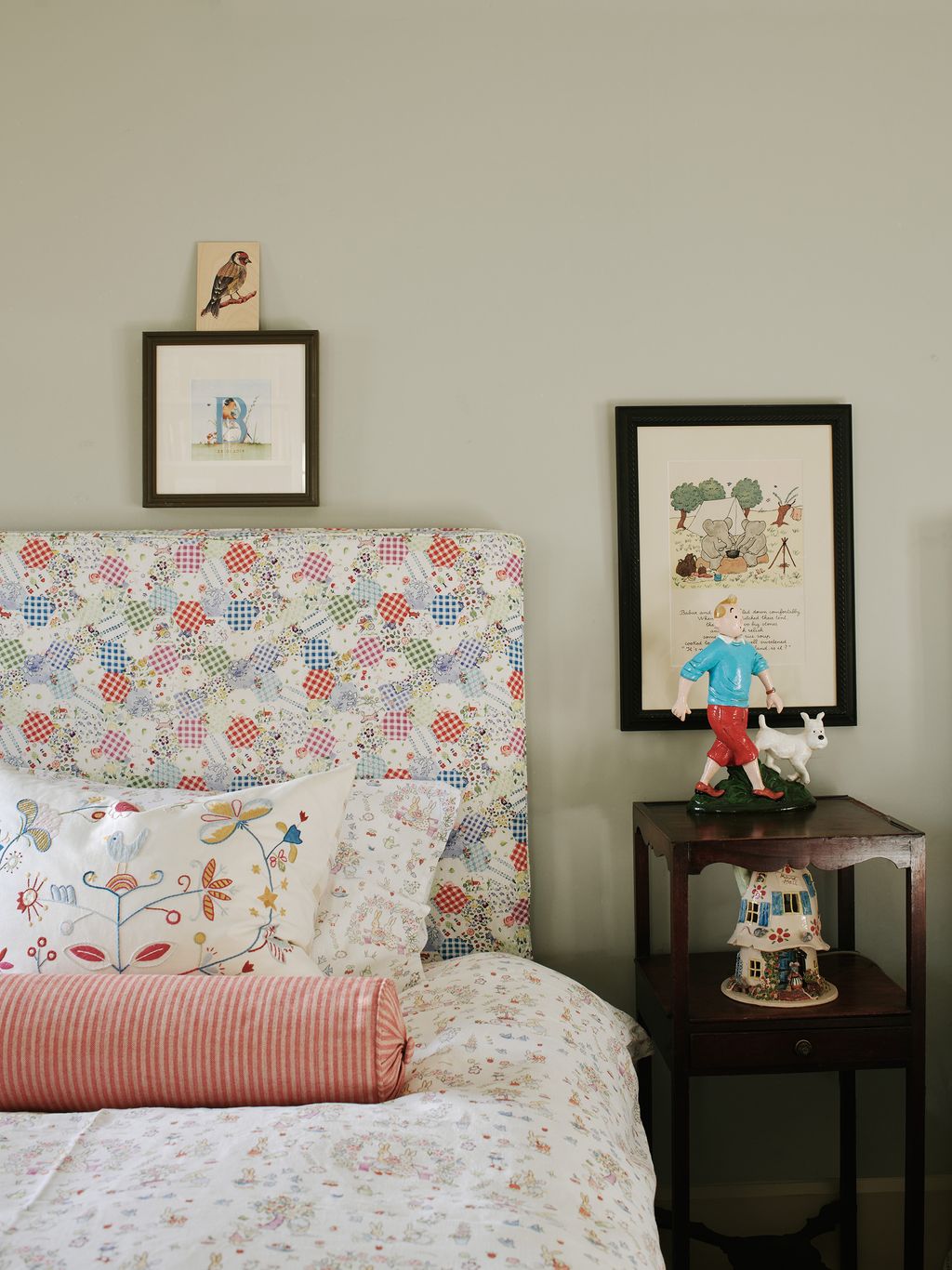 A second children's bedroom features twin beds upholstered in a fabric from Tinker Tinker. The cushions are antique and...