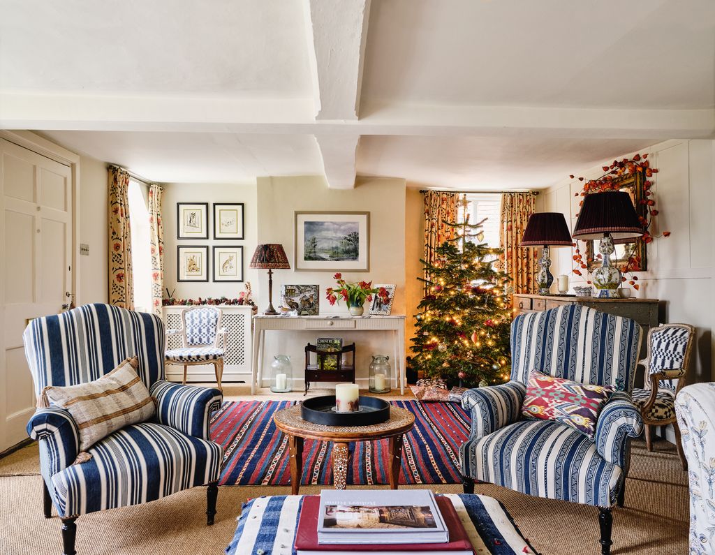 A pair of antique chairs bought from a French market and recovered in a 19thcentury Turkish stripe provides an inviting...